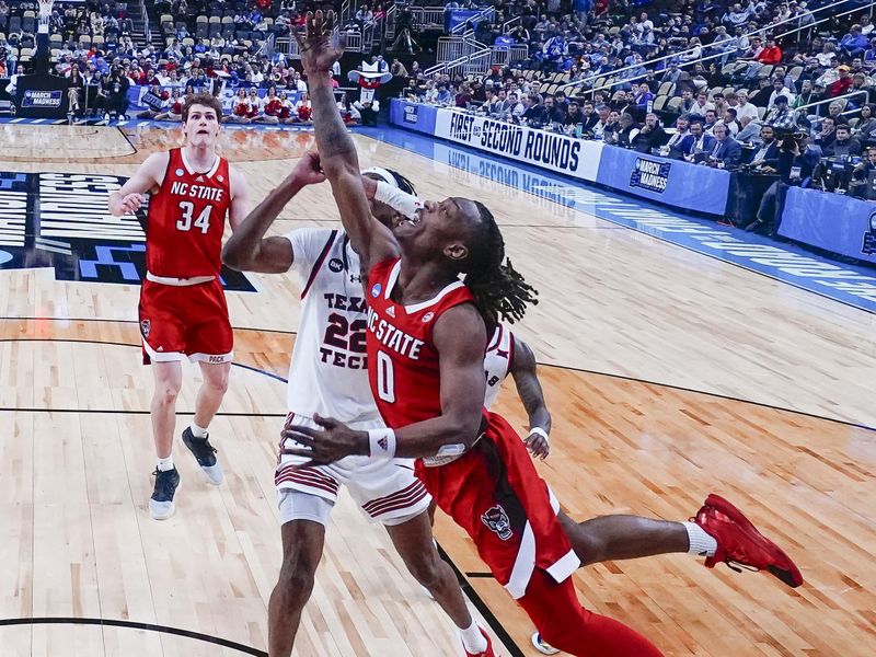 Mar 21, 2024; Pittsburgh, PA, USA; Texas Tech Red Raiders guard Chance McMillian (0) shoots a layup against Texas Tech Red Raiders forward Warren Washington (22) during the second half at PPG Paints Arena. Mandatory Credit: Gregory Fisher-USA TODAY Sports