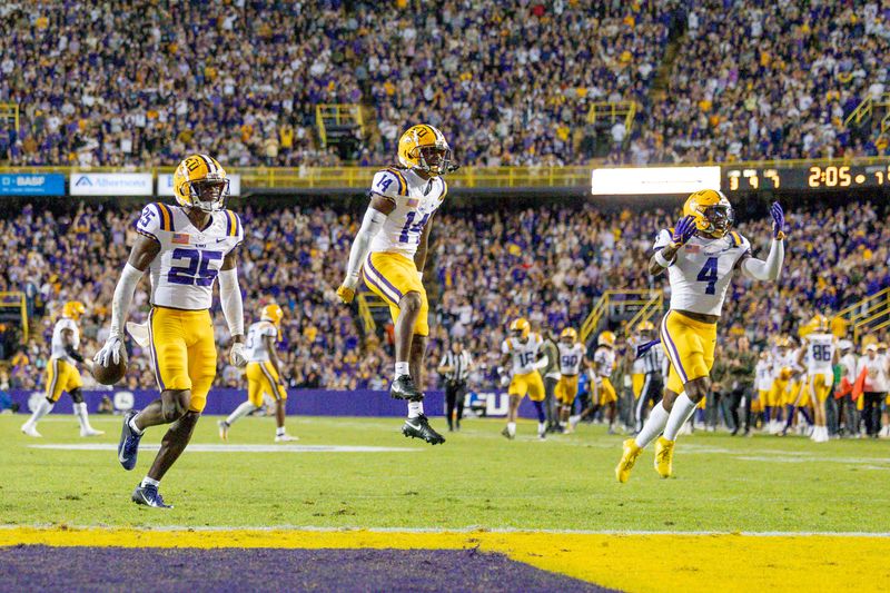 Nov 11, 2023; Baton Rouge, Louisiana, USA; LSU Tigers safety Javien Toviano (25) recovers a fumble against the Florida Gators during the first half at Tiger Stadium. Mandatory Credit: Stephen Lew-USA TODAY Sports