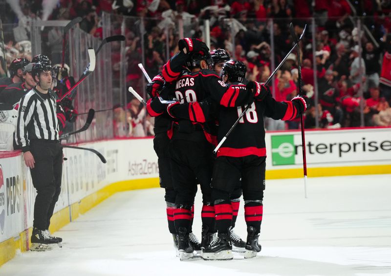 Apr 20, 2024; Raleigh, North Carolina, USA; Carolina Hurricanes center Martin Necas (88) is congratulated by his teammates after his empty net goal against the New York Islanders during the third period in game one of the first round of the 2024 Stanley Cup Playoffs at PNC Arena. Mandatory Credit: James Guillory-USA TODAY Sports