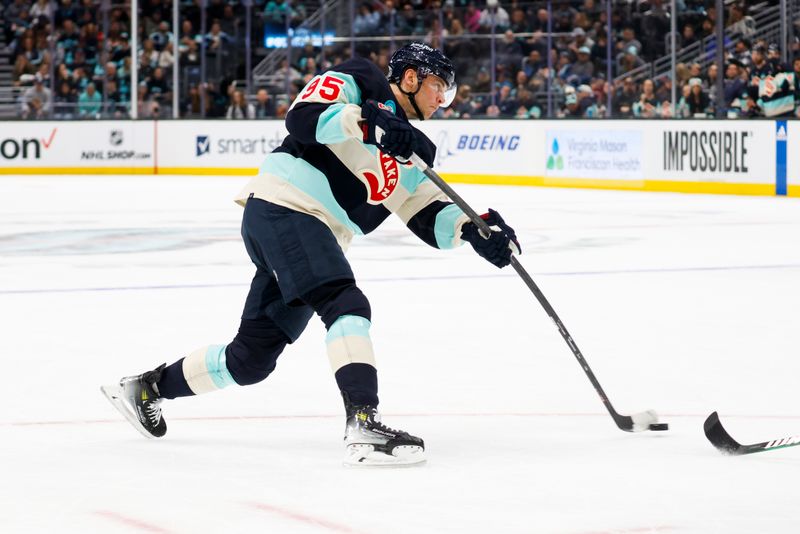 Feb 24, 2024; Seattle, Washington, USA; Seattle Kraken left wing Andre Burakovsky (95) shoots the puck against the Minnesota Wild during the first period at Climate Pledge Arena. Mandatory Credit: Joe Nicholson-USA TODAY Sports