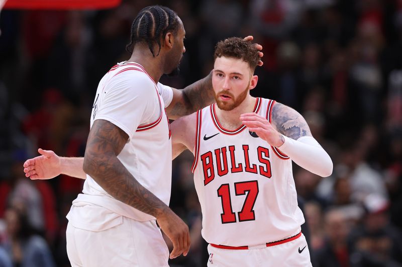 CHICAGO, ILLINOIS - FEBRUARY 28: Andre Drummond #3 and Onuralp Bitim #17 of the Chicago Bulls celebrate against the Cleveland Cavaliers in double overtime at the United Center on February 28, 2024 in Chicago, Illinois. NOTE TO USER: User expressly acknowledges and agrees that, by downloading and or using this photograph, User is consenting to the terms and conditions of the Getty Images License Agreement. (Photo by Michael Reaves/Getty Images)