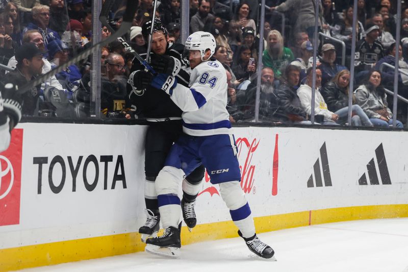 Mar 23, 2024; Los Angeles, California, USA; Tampa Bay Lighting left wing Tanner Jeannot (84) checks Los Angeles Kings defensemen Mikey Anderson (44) during the third period of an NHL hockey game at Crypto.com Arena. Mandatory Credit: Yannick Peterhans-USA TODAY Sports