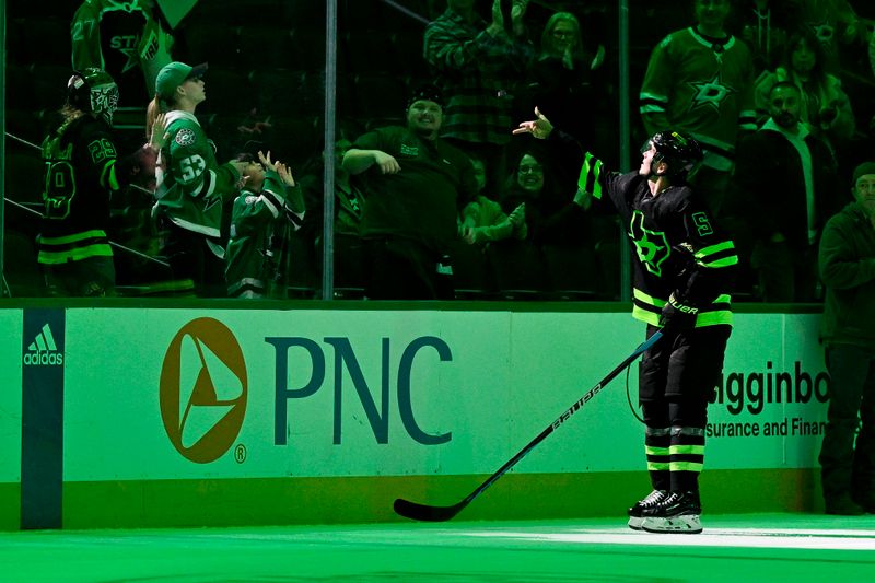 Jan 10, 2024; Dallas, Texas, USA; Dallas Stars defenseman Nils Lundkvist (5) throws a puck to the fans after he is named the number one star in the Stars victory  over the Minnesota Wild at the American Airlines Center. Mandatory Credit: Jerome Miron-USA TODAY Sports