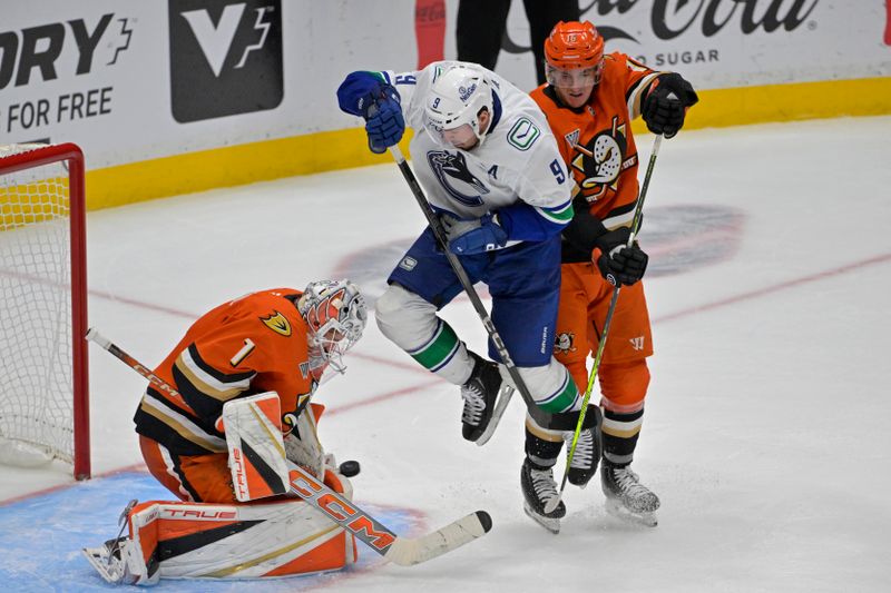 Nov 5, 2024; Anaheim, California, USA;  Vancouver Canucks center J.T. Miller (9) gets in front of Anaheim Ducks center Ryan Strome (16) to score past goaltender Lukas Dostal (1) in the third period at Honda Center. Mandatory Credit: Jayne Kamin-Oncea-Imagn Images