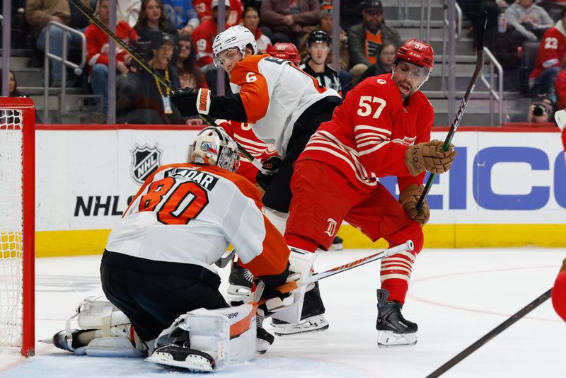 Mar 28, 2026; Detroit, Michigan, USA;  Philadelphia Flyers goaltender Dan Vladar (80) makes a save on Detroit Red Wings left wing David Perron (57) in the second period at Little Caesars Arena. Mandatory Credit: Rick Osentoski-Imagn Images
