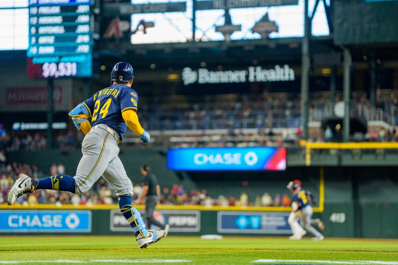 Apr 13, 2025; Phoenix, Arizona, USA;  Milwaukee Brewers catcher William Contreras (24) hits a home run in the second inning against the Arizona Diamondbacks at Chase Field. Mandatory Credit: Allan Henry-Imagn Images