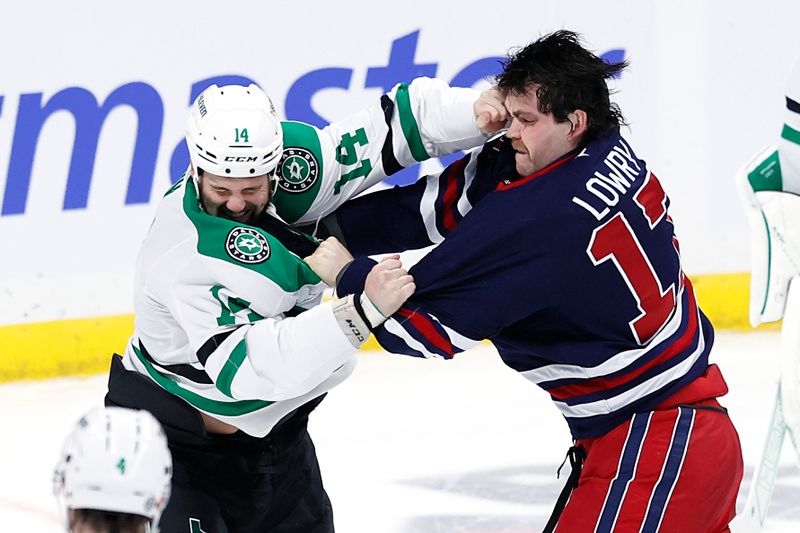 Nov 9, 2024; Winnipeg, Manitoba, CAN; Dallas Stars left wing Jamie Benn (14) and Winnipeg Jets center Adam Lowry (17) fight in the third period at Canada Life Centre. Mandatory Credit: James Carey Lauder-Imagn Images