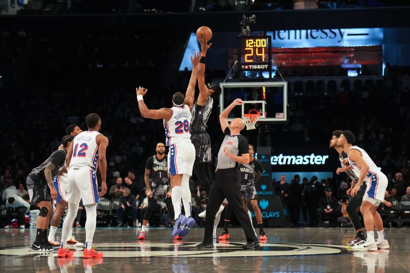 BROOKLYN, NY - FEBRUARY 12: Guerschon Yabusele #28 of the Philadelphia 76ers and Nicolas Claxton #33 of the Brooklyn Nets go up for the opening tip off on February 12, 2025 at Barclays Center in Brooklyn, New York. NOTE TO USER: User expressly acknowledges and agrees that, by downloading and or using this Photograph, user is consenting to the terms and conditions of the Getty Images License Agreement. Mandatory Copyright Notice: Copyright 2025 NBAE (Photo by Jesse D. Garrabrant/NBAE via Getty Images)