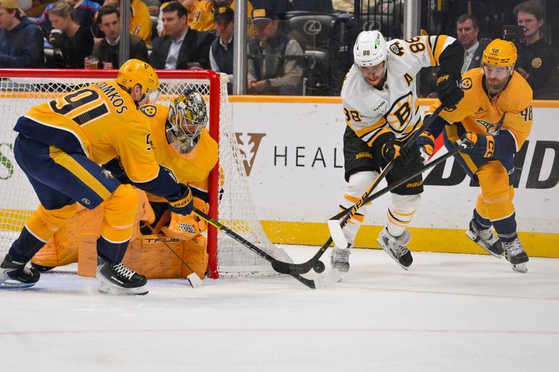 Mar 5, 2026; Nashville, Tennessee, USA;  Nashville Predators center Steven Stamkos (91) and defenseman Nick Perbix (48) blocks the shot of Boston Bruins right wing David Pastrnak (88) during the second period at Bridgestone Arena. Mandatory Credit: Steve Roberts-Imagn Images