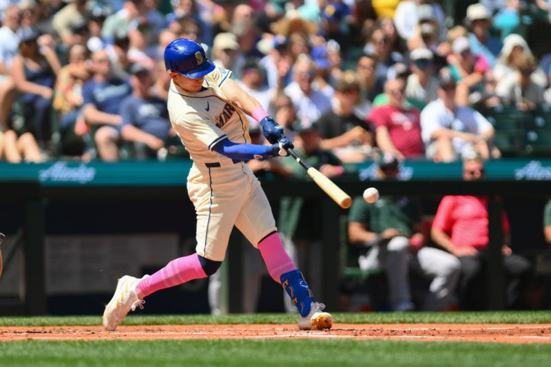 May 12, 2024; Seattle, Washington, USA; Seattle Mariners left fielder Sam Haggerty (0) hits an RBI single against the Oakland Athletics during the second inning at T-Mobile Park. Mandatory Credit: Steven Bisig-USA TODAY Sports