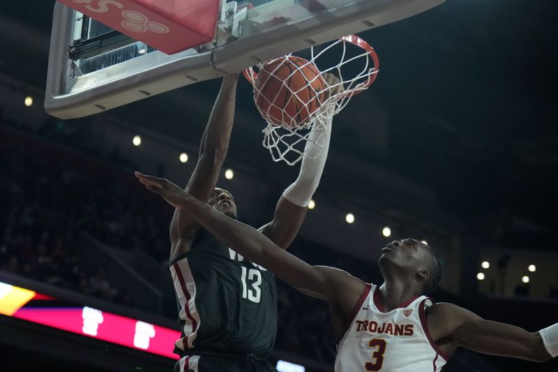 Jan 10, 2024; Los Angeles, California, USA; Washington State Cougars forward Isaac Jones (13) dunks the ball against Southern California Trojans forward Vincent Iwuchukwu (3) in the first half at Galen Center. Mandatory Credit: Kirby Lee-USA TODAY Sports