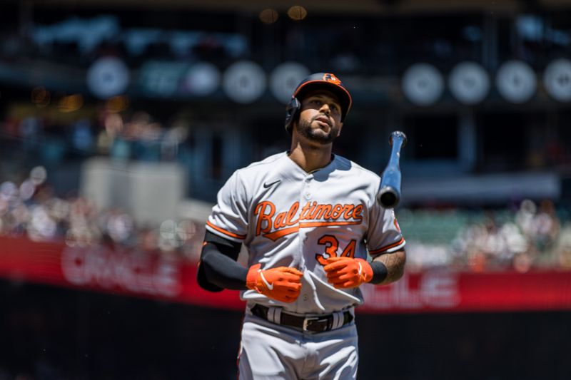 Jun 4, 2023; San Francisco, California, USA;  Baltimore Orioles center fielder Aaron Hicks (34) is walked by San Francisco Giants starting pitcher Anthony DeSclafani (26) during the third inning at Oracle Park. Mandatory Credit: John Hefti-USA TODAY Sports