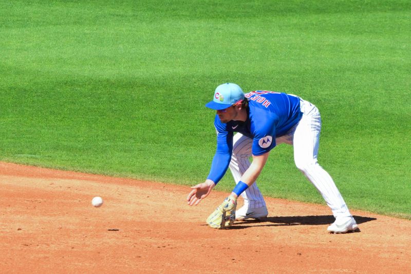 Feb 27, 2026; Mesa, Arizona, USA; Chicago Cubs second baseman Nico Hoerner (2) fields a ball in the third inning against the Cleveland Guardians at Sloan Park. Mandatory Credit: Matt Kartozian-Imagn Images