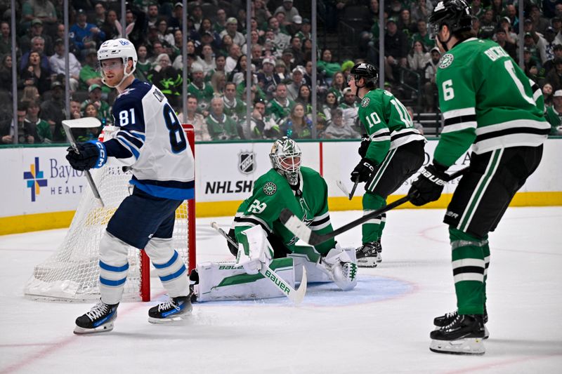 Apr 10, 2025; Dallas, Texas, USA; Winnipeg Jets left wing Kyle Connor (81) scores a goal against Dallas Stars goaltender Jake Oettinger (29) as center Oskar Back (10) and defenseman Lian Bichsel (6) look on during the third period at the American Airlines Center. Mandatory Credit: Jerome Miron-Imagn Images