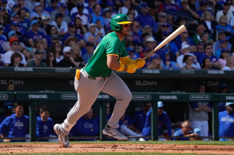 Mar 14, 2024; Mesa, Arizona, USA; Oakland Athletics first baseman Ryan Noda (49) hits a single against the Chicago Cubs in the third inning at Sloan Park. Mandatory Credit: Rick Scuteri-USA TODAY Sports