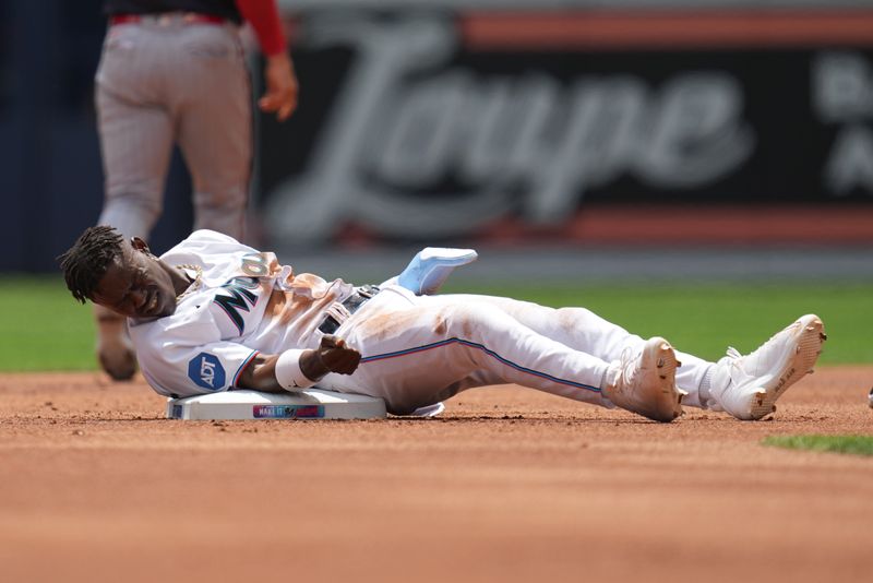 Apr 5, 2023; Miami, Florida, USA;  Miami Marlins center fielder Jazz Chisholm Jr. (2) gets up slowly after getting tagged out trying to steal second base in the first inning against the Minnesota Twins at loanDepot Park. Mandatory Credit: Jim Rassol-USA TODAY Sports