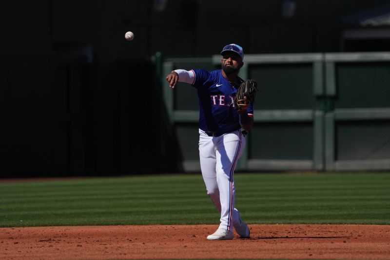 Mar 4, 2024; Surprise, Arizona, USA; Texas Rangers shortstop Ezequiel Duran (20) throws to first against the Los Angeles Angels during the third inning at Surprise Stadium. Mandatory Credit: Joe Camporeale-USA TODAY Sports