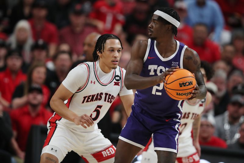 Feb 20, 2024; Lubbock, Texas, USA;  TCU Horned Frogs forward Emanuel Miller (2) looks to pass the ball against Texas Tech Red Raiders guard Darrion Williams (5) in the first half at United Supermarkets Arena. Mandatory Credit: Michael C. Johnson-USA TODAY Sports