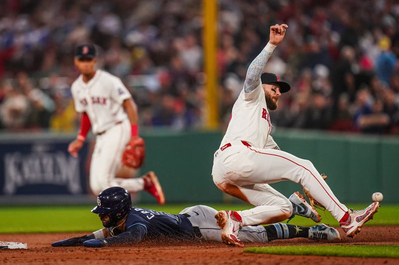 Jun 10, 2025; Boston, Massachusetts, USA; Tampa Bay Rays shortstop José Caballero (77) steals second base against Boston Red Sox shortstop Trevor Story (10) in the fifth inning at Fenway Park. Mandatory Credit: David Butler II-Imagn Images