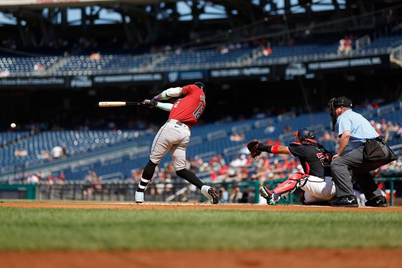 Jun 19, 2024; Washington, District of Columbia, USA; Arizona Diamondbacks outfielder Lourdes Gurriel Jr. (12) singles against the Washington Nationals during the first inning at Nationals Park. Mandatory Credit: Geoff Burke-USA TODAY Sports