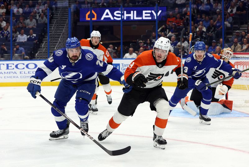 Nov 7, 2024; Tampa, Florida, USA; Tampa Bay Lightning left wing Nick Paul (20) and Philadelphia Flyers defenseman Jamie Drysdale (9) skates to control the puck during the third period at Amalie Arena. Mandatory Credit: Kim Klement Neitzel-Imagn Images