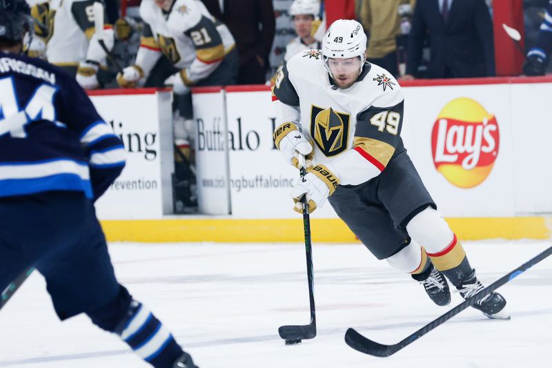 Jan 6, 2026; Winnipeg, Manitoba, CAN; Vegas Golden Knights forward Ivan Barbashev (49) skates in on Winnipeg Jets defenseman Josh Morrissey (44) during the first period at Canada Life Centre. Mandatory Credit: Terrence Lee-Imagn Images