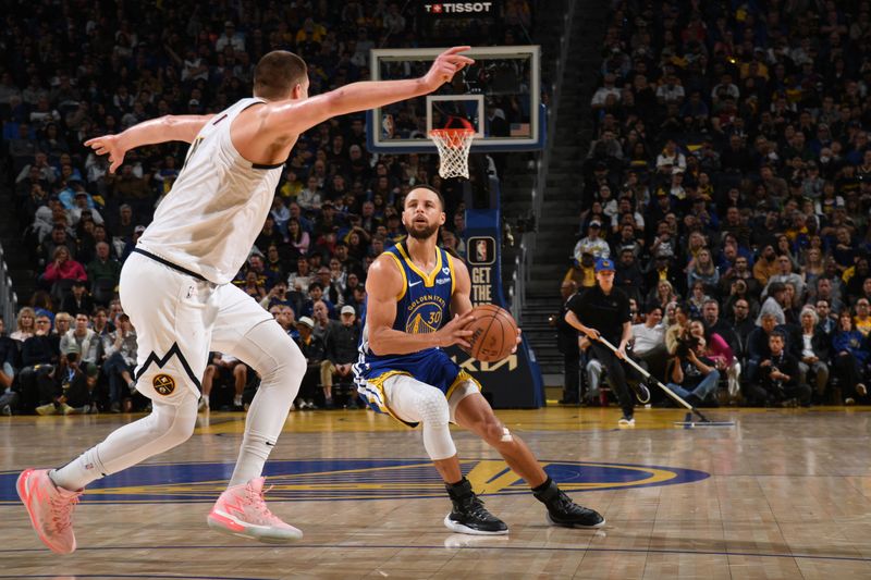 SAN FRANCISCO, CA - FEBRUARY 25:  Stephen Curry #30 of the Golden State Warriors handles the ball during the game against the Denver Nuggets on February 25, 2024 at Chase Center in San Francisco, California. NOTE TO USER: User expressly acknowledges and agrees that, by downloading and or using this photograph, user is consenting to the terms and conditions of Getty Images License Agreement. Mandatory Copyright Notice: Copyright 2024 NBAE (Photo by Noah Graham/NBAE via Getty Images)