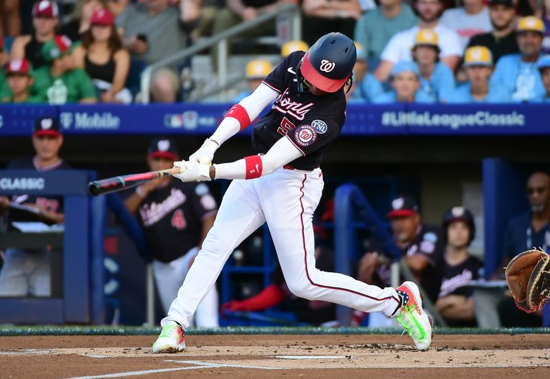 Aug 20, 2023; Williamsport, Pennsylvania, USA; Washington Nationals shortstop CJ Abrams (5) singles in the first inning against the Philadelphia Phillies at Muncy Bank Ballpark at Historic Bowman Field. Mandatory Credit: Evan Habeeb-USA TODAY Sports