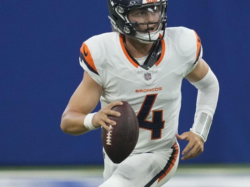 Denver Broncos quarterback Zach Wilson (4) looks to pass against the Indianapolis Colts during the fourth quarter of a preseason NFL football game, Sunday, Aug. 11, 2024, in Westfield, Ind. (AP Photo/Darron Cummings)