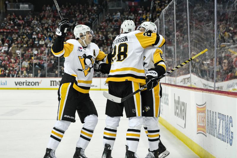 Apr 2, 2024; Newark, New Jersey, USA; Pittsburgh Penguins right wing Rickard Rakell (67) celebrates with teammates after scoring a goal against the New Jersey Devils during the third period at Prudential Center. Mandatory Credit: John Jones-USA TODAY Sports