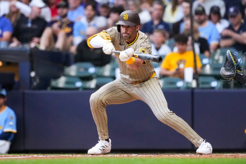 Jun 6, 2025; Milwaukee, Wisconsin, USA;  San Diego Padres left fielder Tyler Wade (14) bunts during the third inning against the Milwaukee Brewers at American Family Field. Mandatory Credit: Jeff Hanisch-Imagn Images