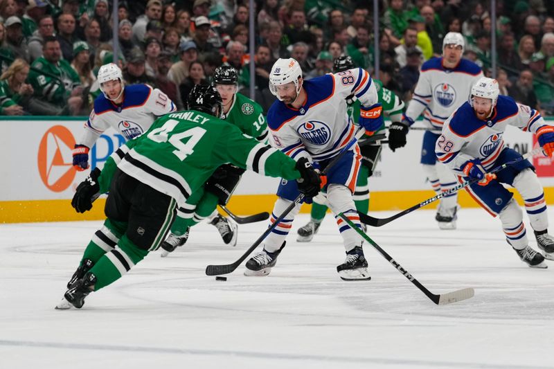 Feb 17, 2024; Dallas, Texas, USA; Edmonton Oilers center Sam Gagner (89) controls the puck against Dallas Stars defenseman Joel Hanley (44) during the first period at American Airlines Center. Mandatory Credit: Chris Jones-USA TODAY Sports