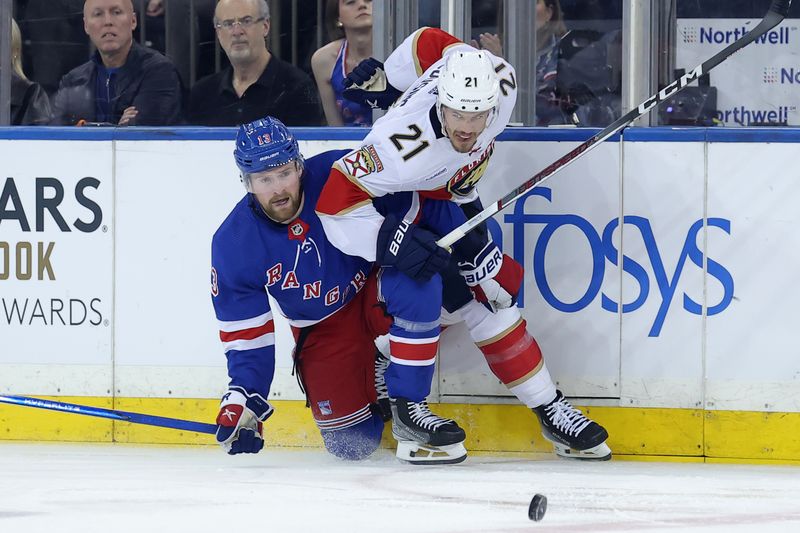 May 22, 2024; New York, New York, USA; New York Rangers left wing Alexis Lafreniere (13) and Florida Panthers center Nick Cousins (21) fight for the puck during the first period of game one of the Eastern Conference Final of the 2024 Stanley Cup Playoffs at Madison Square Garden. Mandatory Credit: Brad Penner-USA TODAY Sports