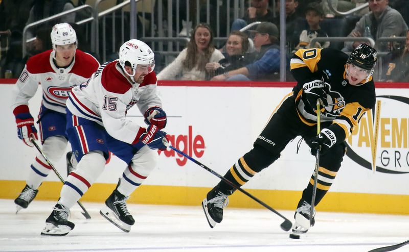 Nov 2, 2024; Pittsburgh, Pennsylvania, USA;  Pittsburgh Penguins left wing Drew O'Connor (10) passes the puck against Montreal Canadiens center Alex Newhook (15) during the third period at PPG Paints Arena. Mandatory Credit: Charles LeClaire-Imagn Images