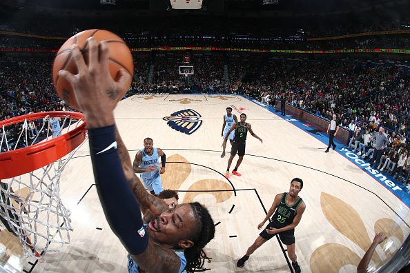 NEW ORLEANS, LA - DECEMBER 26: Ja Morant #12 of the Memphis Grizzlies dunks the ball during the game against the New Orleans Pelicans on December 26, 2023 at the Smoothie King Center in New Orleans, Louisiana. NOTE TO USER: User expressly acknowledges and agrees that, by downloading and or using this Photograph, user is consenting to the terms and conditions of the Getty Images License Agreement. Mandatory Copyright Notice: Copyright 2023 NBAE (Photo by Layne Murdoch Jr./NBAE via Getty Images)