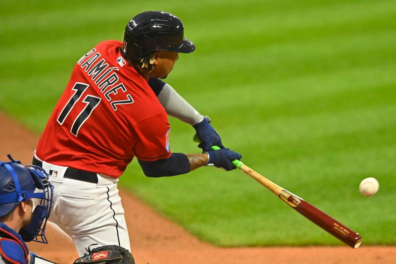 Aug 23, 2023; Cleveland, Ohio, USA; Cleveland Guardians third baseman Jose Ramirez (11) hits a solo home run in the first inning against the Los Angeles Dodgers at Progressive Field. Mandatory Credit: David Richard-USA TODAY Sports