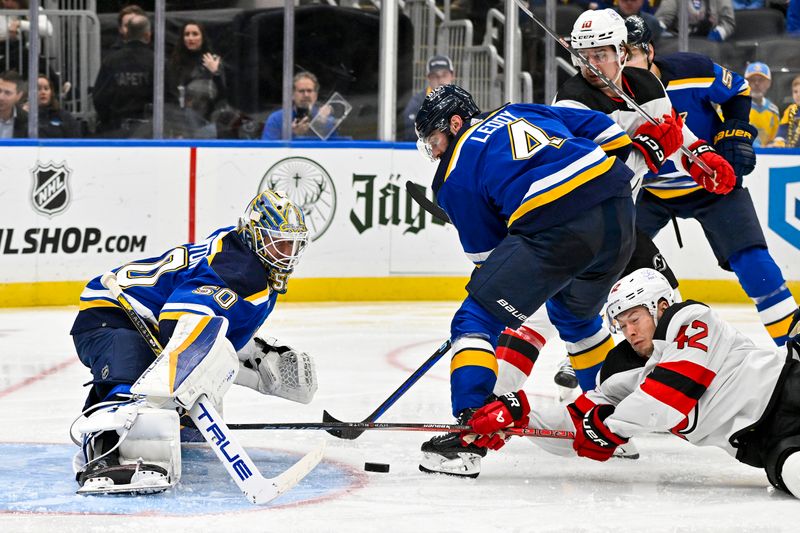 Nov 3, 2023; St. Louis, Missouri, USA;  St. Louis Blues goaltender Jordan Binnington (50) defends the net against New Jersey Devils center Curtis Lazar (42) during the third period at Enterprise Center. Mandatory Credit: Jeff Curry-USA TODAY Sports