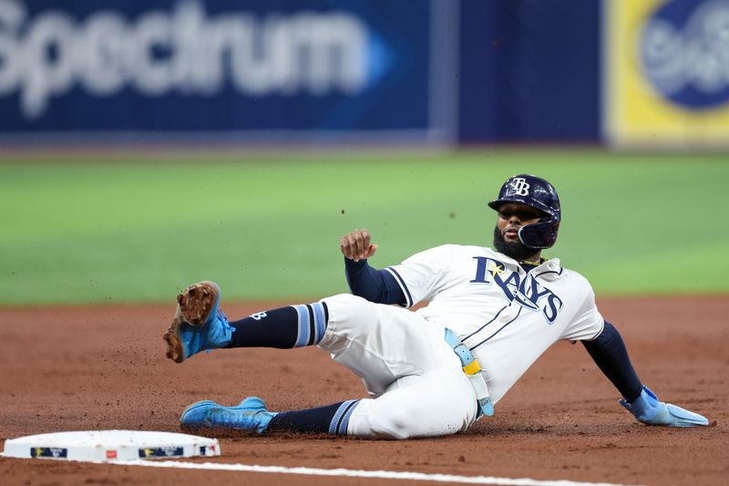 Sep 2, 2024; St. Petersburg, Florida, USA; Tampa Bay Rays third baseman Junior Caminero (13) slide into third base against the Los Minnesota Twins in the first inning at Tropicana Field. Mandatory Credit: Nathan Ray Seebeck-USA TODAY Sports