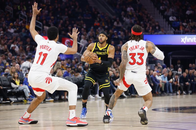 SAN FRANCISCO, CALIFORNIA - JANUARY 07: Moses Moody #4 of the Golden State Warriors looks to shoot the ball against Jontay Porter #11 and Gary Trent Jr. #33 of the Toronto Raptors in the first quarter at Chase Center on January 07, 2024 in San Francisco, California. NOTE TO USER: User expressly acknowledges and agrees that, by downloading and or using this photograph, User is consenting to the terms and conditions of the Getty Images License Agreement. (Photo by Lachlan Cunningham/Getty Images)