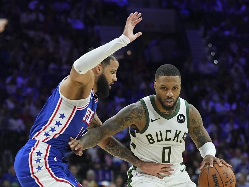 PHILADELPHIA, PENNSYLVANIA - OCTOBER 23: Damian Lillard #0 of the Milwaukee Bucks dribbles the ball against Caleb Martin #16 of the Philadelphia 76ers in the second half at the Wells Fargo Center on October 23, 2024 in Philadelphia, Pennsylvania. The Bucks defeated the 76ers 124-109. NOTE TO USER: User expressly acknowledges and agrees that, by downloading and/or using this photograph, user is consenting to the terms and conditions of the Getty Images License Agreement. (Photo by Mitchell Leff/Getty Images)