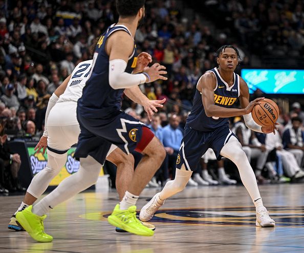 DENVER, CO - DECEMBER 28: Peyton Watson (8) of the Denver Nuggets looks to pass to Jamal Murray (27) as David Roddy (21) of the Memphis Grizzlies defends during the third quarter at Ball Arena in Denver on Thursday, December 28, 2023. (Photo by AAron Ontiveroz/The Denver Post)