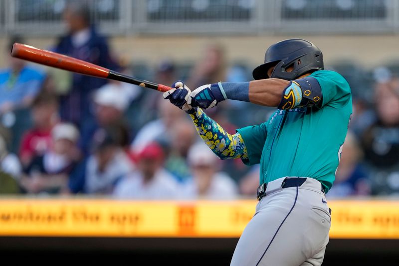 May 8, 2024; Minneapolis, Minnesota, USA; Seattle Mariners center fielder Julio Rodriguez (44) hits a single against the Minnesota Twins in the first inning at Target Field. Mandatory Credit: Jesse Johnson-USA TODAY Sports