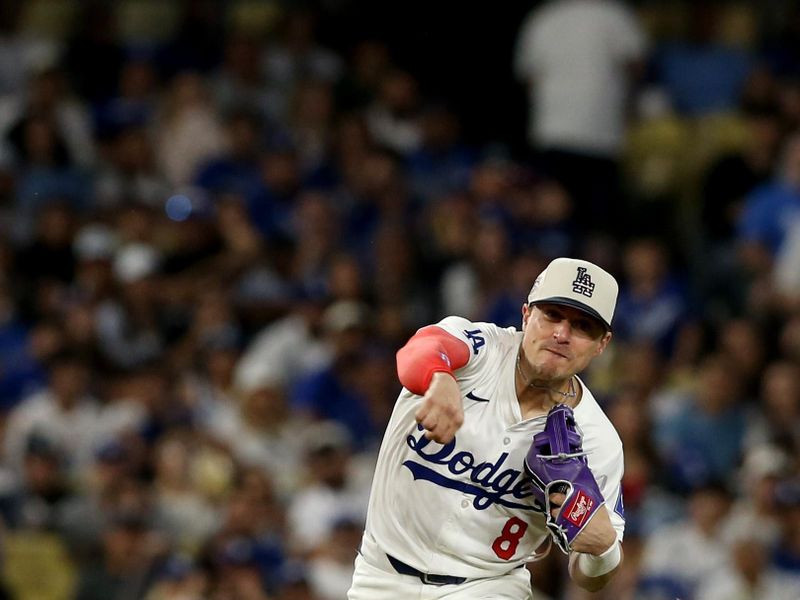 Jul 4, 2024; Los Angeles, California, USA; Los Angeles Dodgers third baseman Enrique Hernandez (8) throws to first for an out during the eighth inning against the Arizona Diamondbacks at Dodger Stadium. Mandatory Credit: Jason Parkhurst-USA TODAY Sports