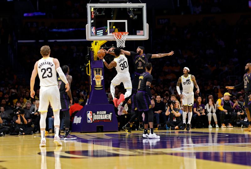 LOS ANGELES, CALIFORNIA - NOVEMBER 21: Anthony Davis #3 of the Los Angeles Lakers attempts to block a layup by Ochai Agbaji #30 of the Utah Jazz during the first half of an NBA In-Season Tournament at Crypto.com Arena on November 21, 2023 in Los Angeles, California. NOTE TO USER: User expressly acknowledges and agrees that, by downloading and or using this photograph, User is consenting to the terms and conditions of the Getty Images License Agreement. (Photo by Kevork Djansezian/Getty Images)