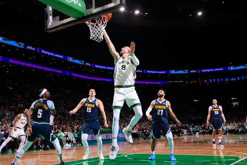 BOSTON, MA - JANUARY 19: Kristaps Porzingis #8 of the Boston Celtics drives to the basket during the game against the Denver Nuggets  on January 19, 2024 at the TD Garden in Boston, Massachusetts. NOTE TO USER: User expressly acknowledges and agrees that, by downloading and or using this photograph, User is consenting to the terms and conditions of the Getty Images License Agreement. Mandatory Copyright Notice: Copyright 2024 NBAE  (Photo by Brian Babineau/NBAE via Getty Images)