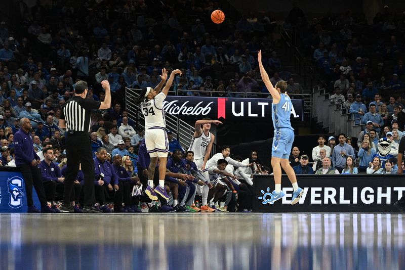 Dec 13, 2025; Omaha, Nebraska, USA;  Kansas State Wildcats guard Nate Johnson (34) shoots over Creighton Bluejays forward Isaac Traudt (41) during the second half at CHI Health Center Omaha. Mandatory Credit: Steven Branscombe-Imagn Images