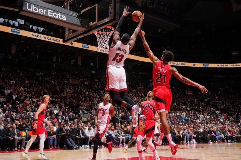 TORONTO, CANADA - JANUARY 17: Bam Adebayo #13 of the Miami Heat rebounds the ball during the game against the Toronto Raptors on January 17, 2024 at the Scotiabank Arena in Toronto, Ontario, Canada.  NOTE TO USER: User expressly acknowledges and agrees that, by downloading and or using this Photograph, user is consenting to the terms and conditions of the Getty Images License Agreement.  Mandatory Copyright Notice: Copyright 2024 NBAE (Photo by Mark Blinch/NBAE via Getty Images)