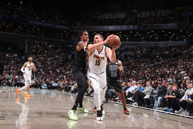 BROOKLYN, NY - OCTOBER 29: Nikola Jokic #15 of the Denver Nuggets looks to pass the ball during the game against the Brooklyn Nets on October 29, 2024 at Barclays Center in Brooklyn, New York. NOTE TO USER: User expressly acknowledges and agrees that, by downloading and or using this Photograph, user is consenting to the terms and conditions of the Getty Images License Agreement. Mandatory Copyright Notice: Copyright 2024 NBAE (Photo by Nathaniel S. Butler/NBAE via Getty Images)