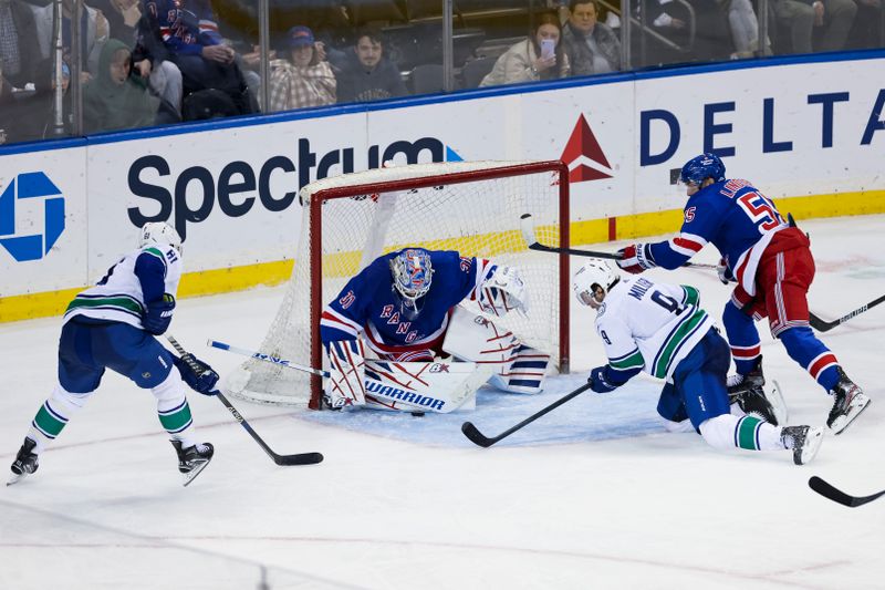 Feb 8, 2023; New York, New York, USA; New York Rangers goaltender Igor Shesterkin (31) makes a save against Vancouver Canucks defenseman Riley Stillman (61) during the third period of a game at Madison Square Garden. Mandatory Credit: Jessica Alcheh-USA TODAY Sports