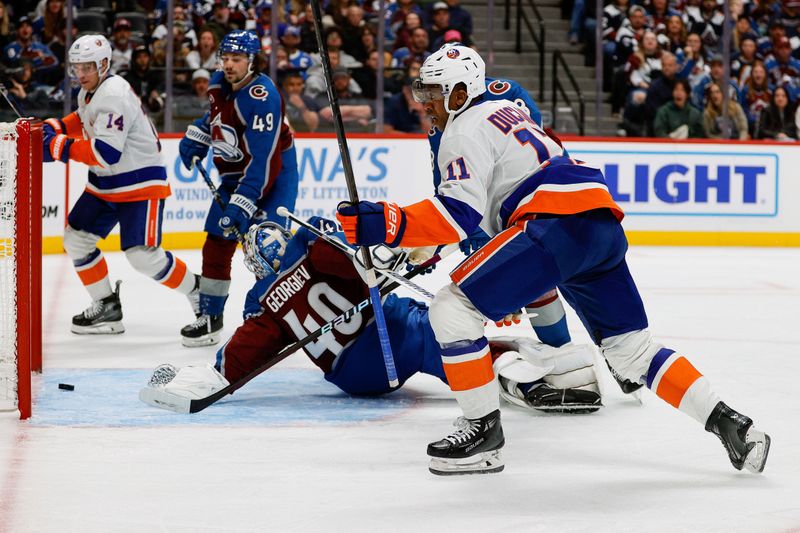 Oct 14, 2024; Denver, Colorado, USA; New York Islanders left wing Anthony Duclair (11) scores a goal against Colorado Avalanche goaltender Alexandar Georgiev (40) in the third period at Ball Arena. Mandatory Credit: Isaiah J. Downing-Imagn Images